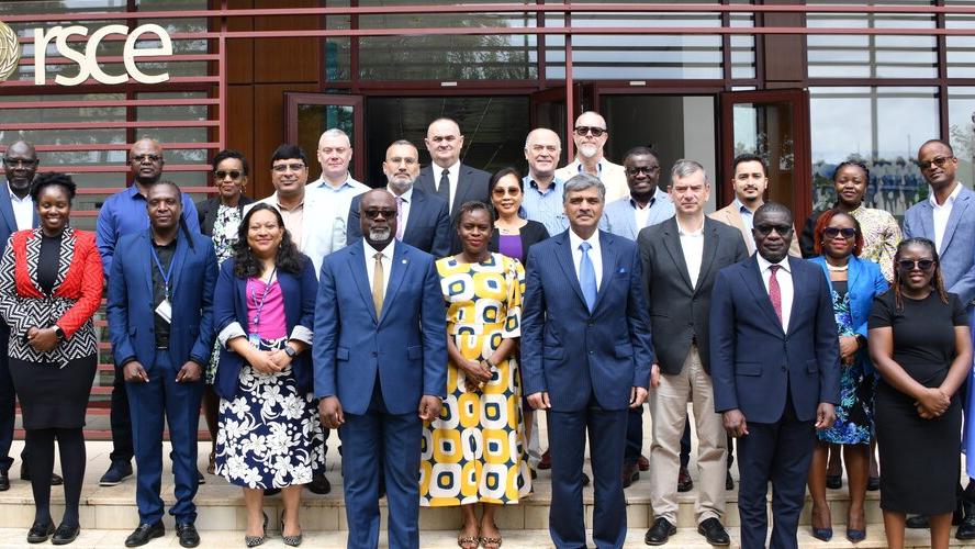 A group of staff stand in a row outside a building