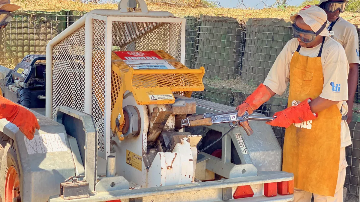 a man is destucting a weapon with a machine