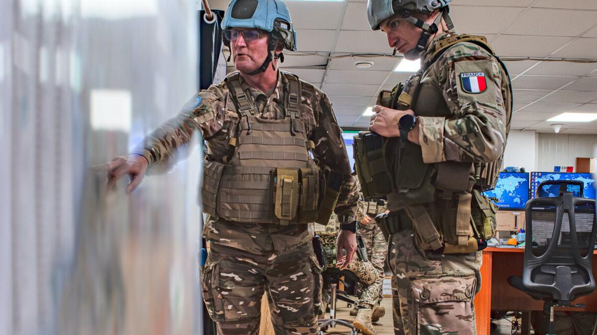 UN peacekeepers consult a map