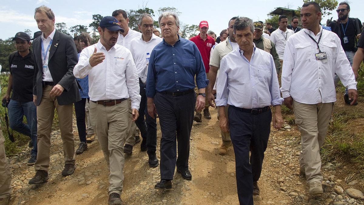 a group of men are walking in a field