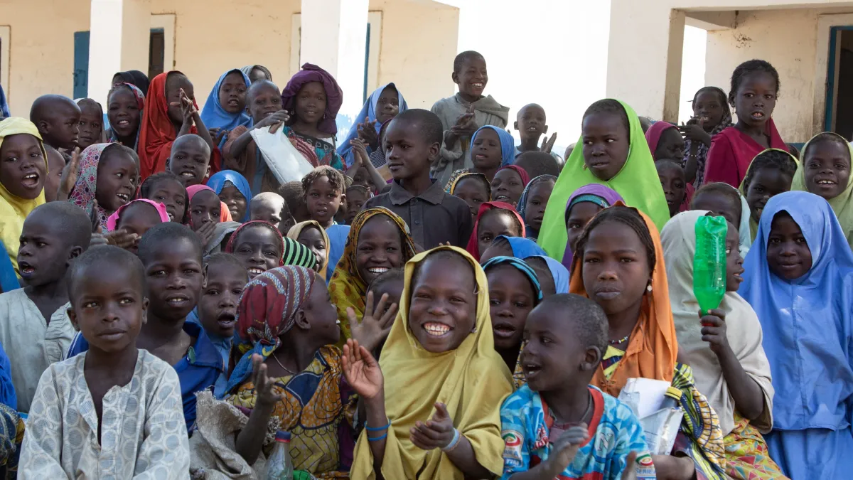 many children are sitting on the floor