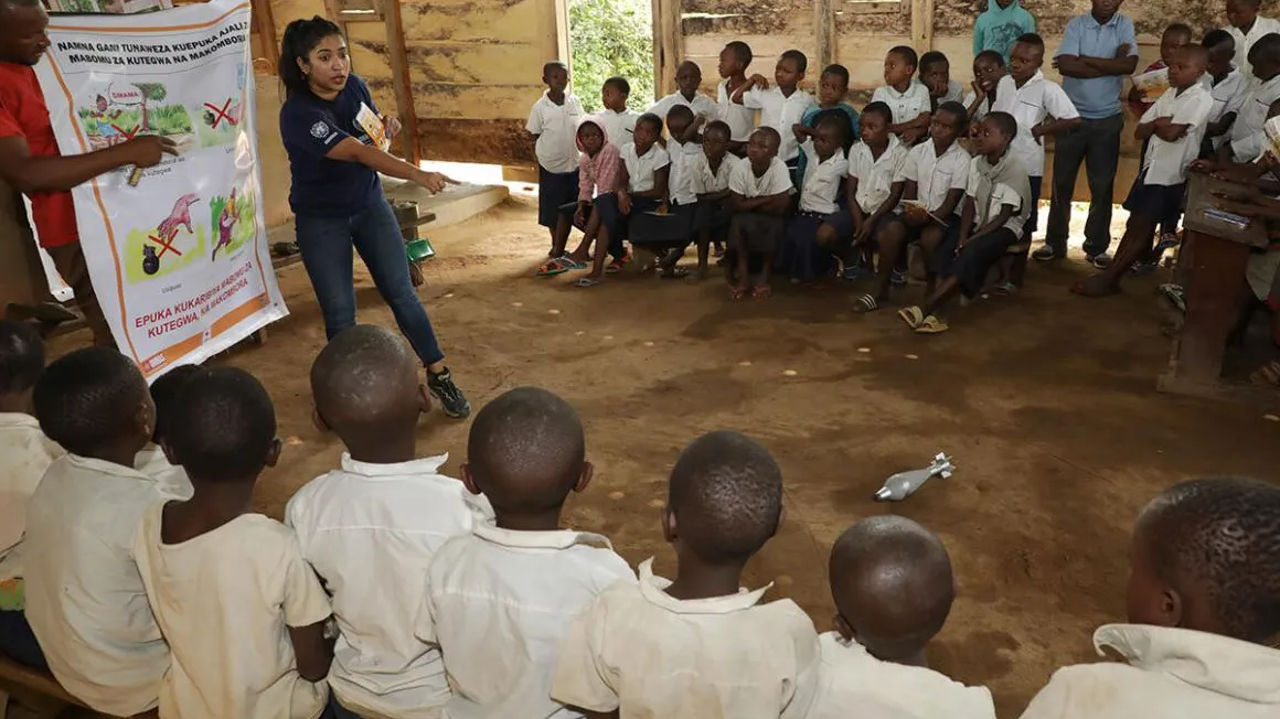 Two people doing EORE to students in DRC