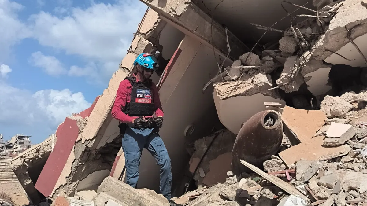 UNMAS assesses an explosive ordnance item among the rubble during an assessment in Gaza. May 2026
