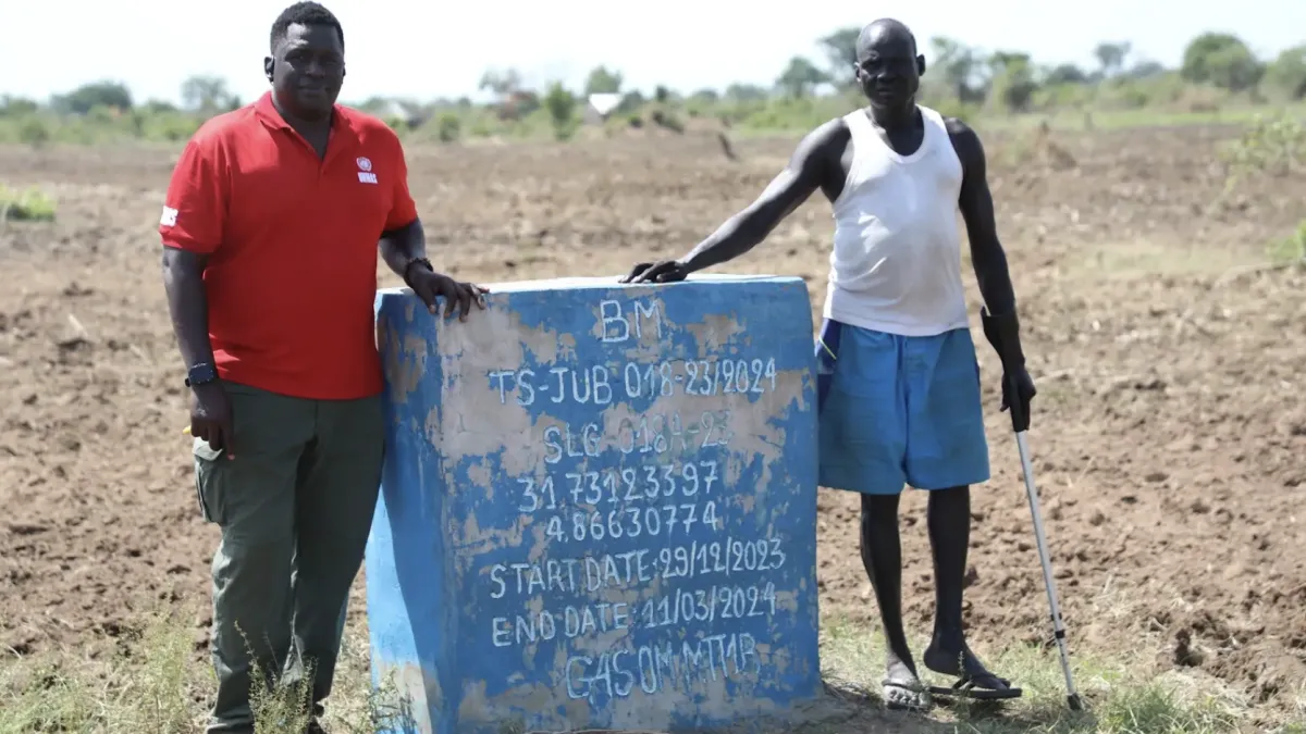 A UNMAS clearance marker on land in Bilinyang Payam that was previously contaminated by explosive hazards and later cleared for safe civilian use. The land is now used for farming and settlement.
