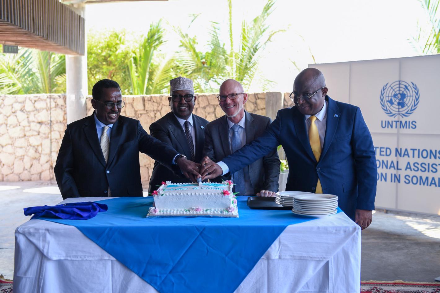 A photo of UN Special Representative James Swan with Somali ministers cutting a cake at the official launch of UNTMIS