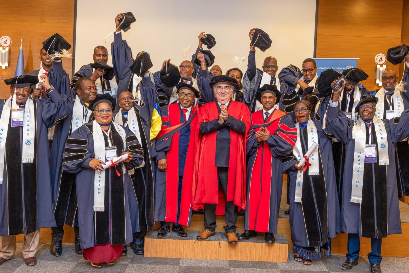 A group of graduates raise their mortarboards with UPEACE Senior officials at the fourth UPEACE graduation ceremony held in Mogadishu, Somalia, on 24 January 2025.