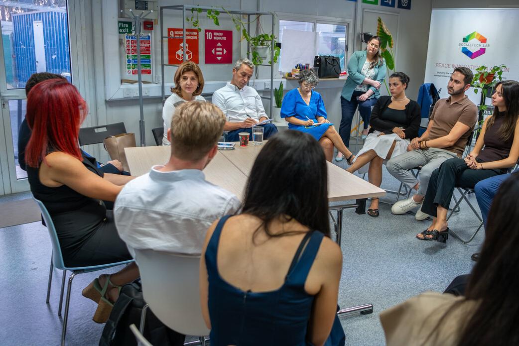 A photo of the Personal Envoy of the Secretary-General on Cyprus, María Ángela Holguín, with a group of participants at an event. 