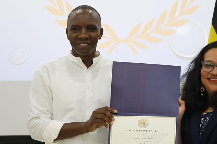 Joshua Byentaka (l) and RSCE Deputy Director, Nalini Contreras (r)