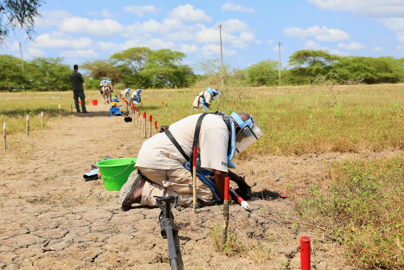 some deminers are doing an accreditation on a field