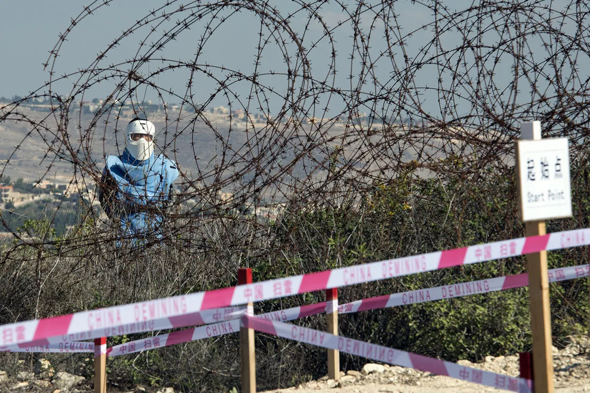 A Chinese deminer works along the Blue Line near Rmeish, south Lebanon.