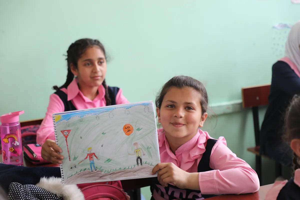 Drawing activity called "painting for peace" at Darraya School in Rural Damascus, focusing on Explosive Ordnance Risk Education.