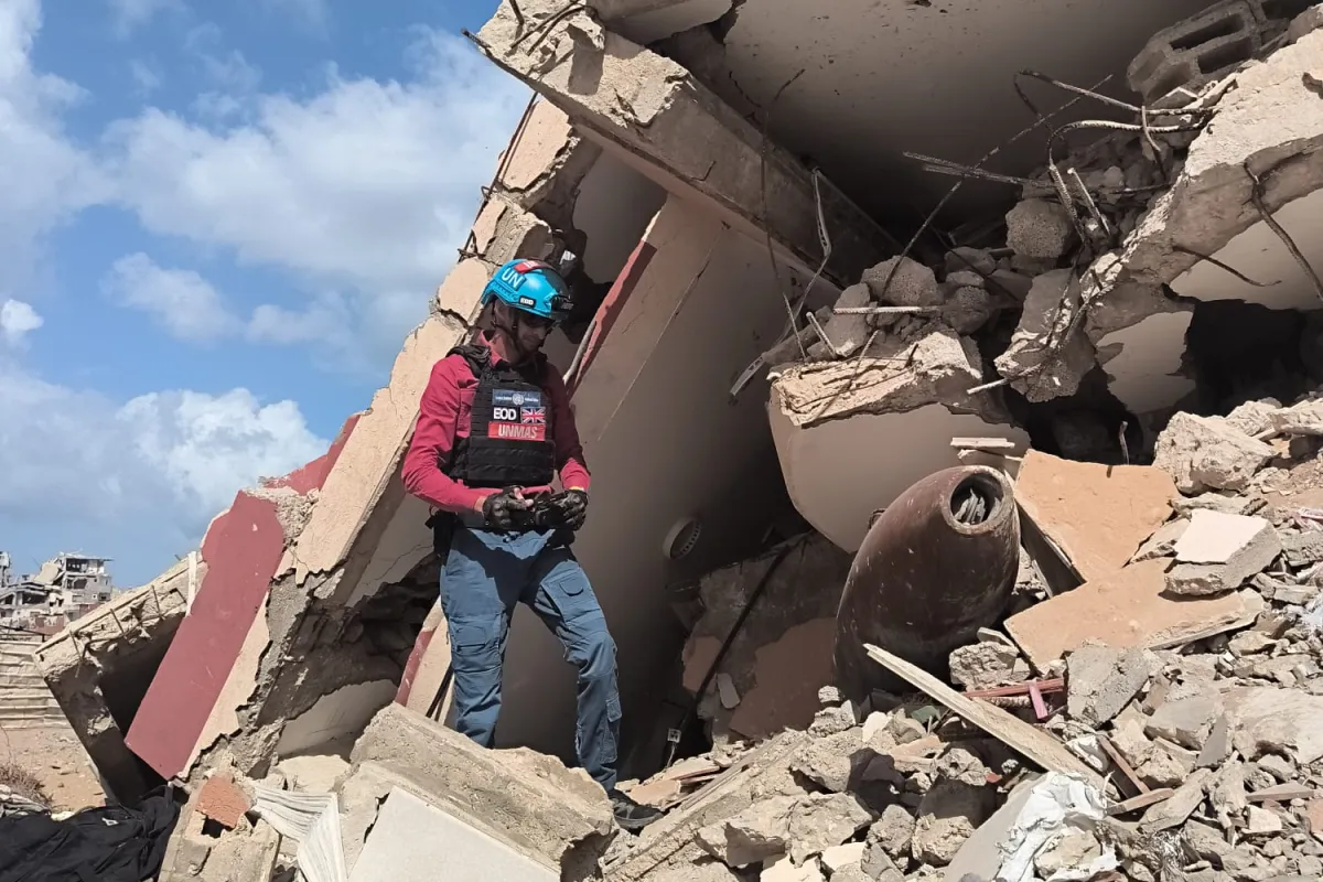 UNMAS assesses an explosive ordnance item among the rubble during an assessment in Gaza. May 2026