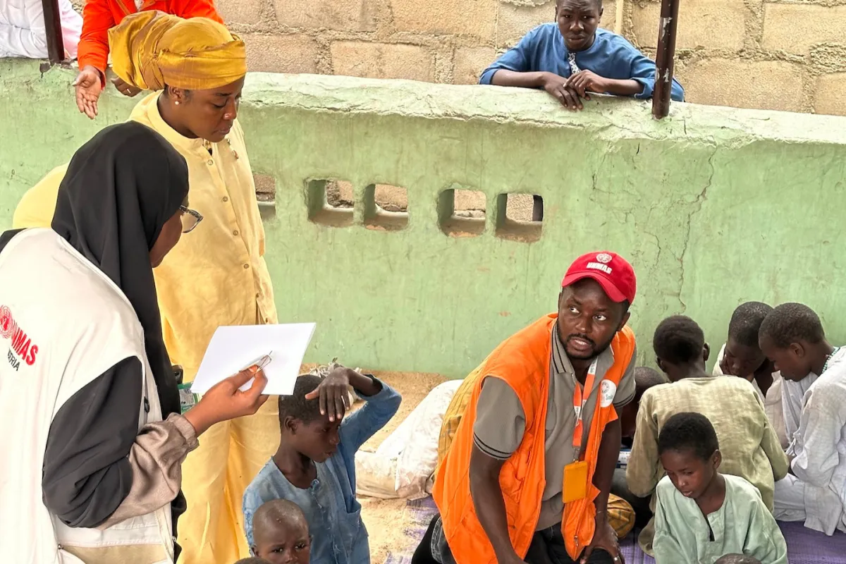 Maryam meets with children during an Explosive Ordnance Risk Education (EORE) session in Borno, Nigeria.
