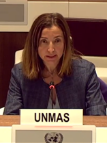 a woman speaking in front of a mic