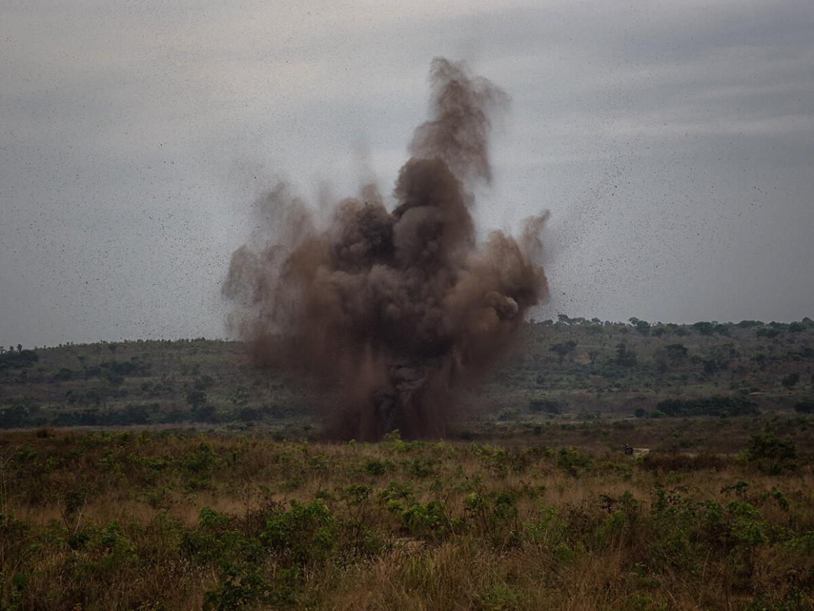 an explosion with smoke in a field