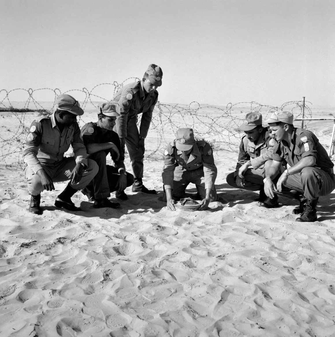 United Nations Emergency Force (UNEF) Soldiers of the Brazilian battalion of UNEF being instructed by Lt. L.G. Lessa on dealing with a landmine. 01 April 1959 .Egypt . UN Photo/JG