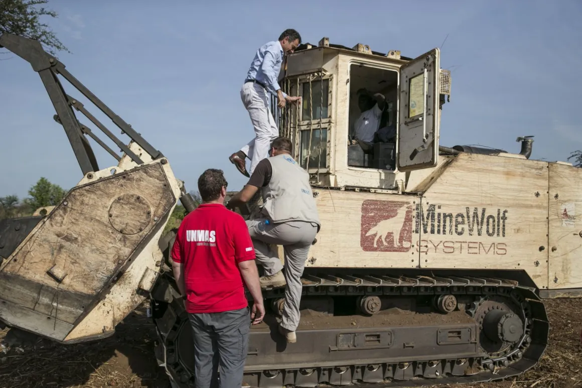 Mr. Lanzer (top left) takes a look at a MineWolf, a mine-clearance machine. 24 March 2015. Ayii, South Sudan . UN Photo/Isaac Billy
