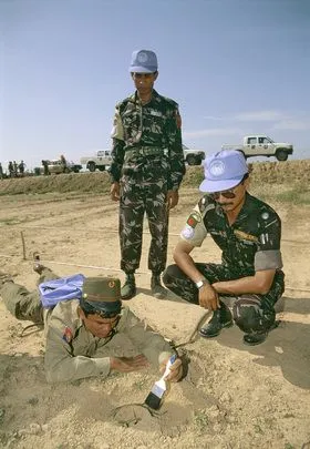 UNTAC peacekeepers from Bangladesh teaching a Cambodian soldier how to deactivate mines. [1992] ​01 January 1992 ​Cambodia​.UN Photo/J Bleibtreu