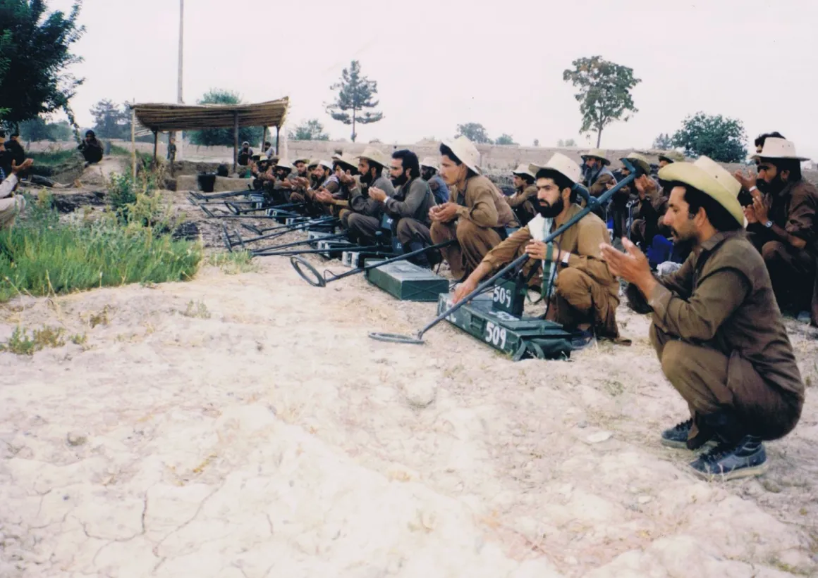 PHOTO: ATC/ Ian Mansfield, Afghan volunteers in mine action during their break for pray.