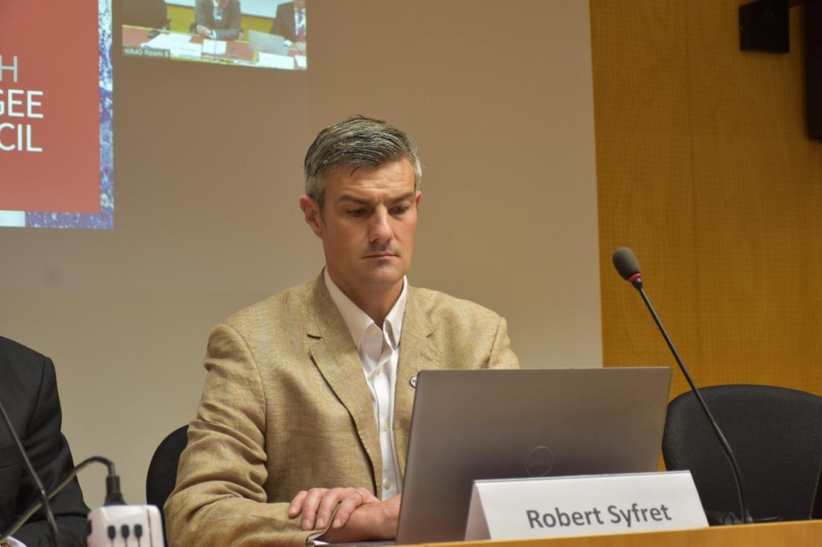A man sitting in front of a laptop