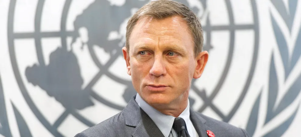a man in front of an UN logo